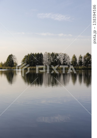 a lake in calm autumn weather at sunset, a wide lake with plants in the autumn at sunset a lake in calm autumn weather at sunset, a wide lake with plants in the autumn at sunset 138394586