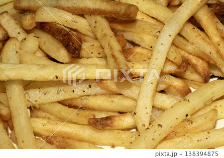 Close up of golden french fries chips fried potatoes tasty junk food Close up of golden french fries chips fried potatoes tasty junk food 138394875