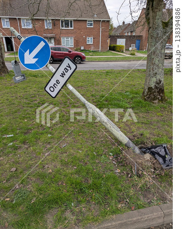 One way sign that a car has driven into a broken knocked over damaged traffic pole One way sign that a car has driven into a broken knocked over damaged traffic pole 138394886