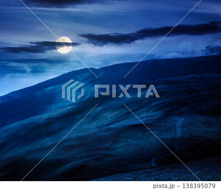 scenic mountain landscape in summer at night. beautiful travel background with rolling hills. lush green grassy hillside in full moon dappled light. narrow telephoto view. mysterious fantasy scenic mountain landscape in summer at night. beautiful travel background with rolling hills. lush green grassy hillside in full moon dappled light. narrow telephoto view. mysterious fantasy 138395079