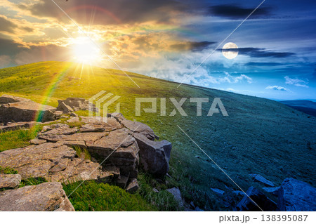 rocks and rolling hills in mountain landscape on summer solstice. day meet night. sun and moon over scenery with green grass on alpine meadow. astrology recreation tourism and wanderlust rocks and rolling hills in mountain landscape on summer solstice. day meet night. sun and moon over scenery with green grass on alpine meadow. astrology recreation tourism and wanderlust 138395087