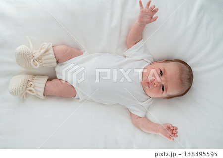 Infant resting on clean bed surface. Concept of safe sleep, pediatric care and healthy newborn development. Infant resting on clean bed surface. Concept of safe sleep, pediatric care and healthy newborn development. 138395595