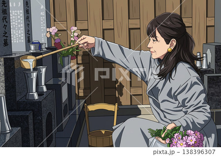お墓に花を供えようとしている女性 138396307