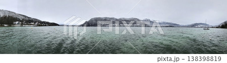 views from the shore of lake annecy after the last snowfall 138398819