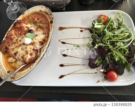 plate of lasagna bolognese accompanied by salad plate of lasagna bolognese accompanied by salad 138398820
