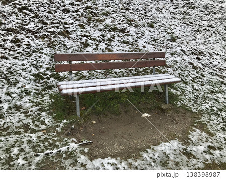 wooden bench covered by snow 138398987