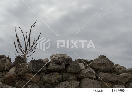 retaining wall formed by stacked rocks retaining wall formed by stacked rocks 138399005