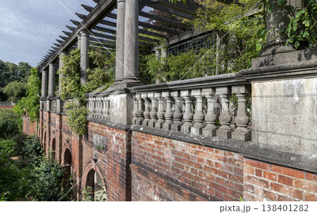 The Hill Garden and Pergola is an Edwardian-era structure overlooking Hampstead Heath. It consists of a timber-trellis walkway elevated by stone Doric columns and a red-brick arched foundation. A The Hill Garden and Pergola is an Edwardian-era structure overlooking Hampstead Heath. It consists of a timber-trellis walkway elevated by stone Doric columns and a red-brick arched foundation. A 138401282