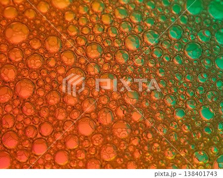 Macro close-up of colorful bubbles in orange and green hues with a shallow depth of field on a smooth surface Macro close-up of colorful bubbles in orange and green hues with a shallow depth of field on a smooth surface 138401743