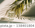 Minimal Glass of Water on Light Background With Soft Tropical Sunlight and Clean Aesthetic 138401804