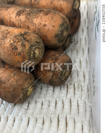 fresh carrots with dirt on them 138402558
