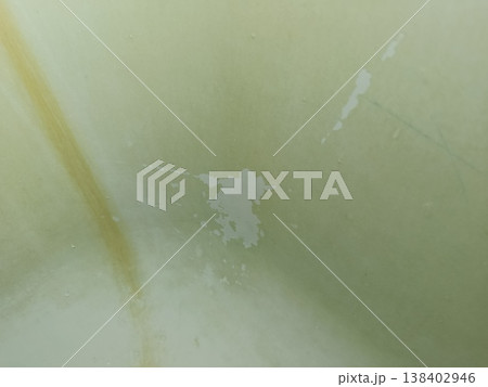 Damaged beige plastic surface showing rust-like stains, scratches, and worn texture, illustrating wear and tear on a dirty material background Damaged beige plastic surface showing rust-like stains, scratches, and worn texture, illustrating wear and tear on a dirty material background 138402946