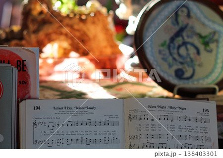 Open Christmas Hymn Book In A Cozy Living Room Open Christmas Hymn Book In A Cozy Living Room 138403301