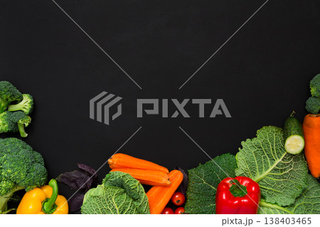 Fresh vegetables border on black background. Vegetarian cooking. Healthy natural food with copy space. Fresh vegetables border on black background. Vegetarian cooking. Healthy natural food with copy space. 138403465