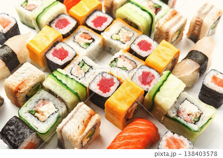 Japanese food restaurant delivery - sushi maki, unagi, tuna and california roll big party platter set isolated on white background, closeup Japanese food restaurant delivery - sushi maki, unagi, tuna and california roll big party platter set isolated on white background, closeup 138403578