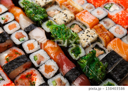 Sushi and rolls pattern background, japanese restaurant delivery closeup. Salmon, unagi, california and other healthy meals 138403586