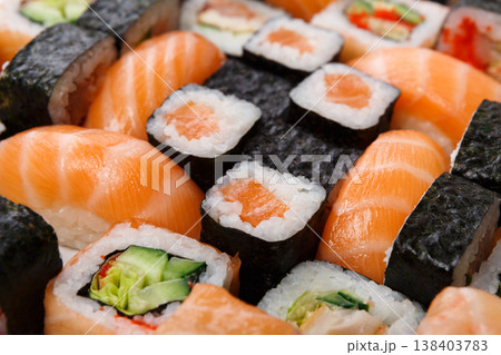 Sushi and rolls pattern background, japanese restaurant delivery top view. Salmon, unagi, california and other healthy meals 138403783