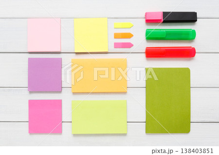Flat lay of office and business stationery supplies - colorful markers, sticky notes and memo blocks, notepad, pen on white rustic wooden board background, top view with copy space, nobody, objects Flat lay of office and business stationery supplies - colorful markers, sticky notes and memo blocks, notepad, pen on white rustic wooden board background, top view with copy space, nobody, objects 138403851