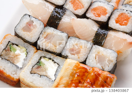 Sushi and rolls closeup background, japanese restaurant delivery. Salmon, unagi, california and other healthy meals Sushi and rolls closeup background, japanese restaurant delivery. Salmon, unagi, california and other healthy meals 138403867