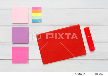 Flat lay of bright office stationery supplies - colorful markers, sticky notes and memo blocks, notepad on white rustic wood background, top view with copy space, nobody, objects Flat lay of bright office stationery supplies - colorful markers, sticky notes and memo blocks, notepad on white rustic wood background, top view with copy space, nobody, objects 138403876
