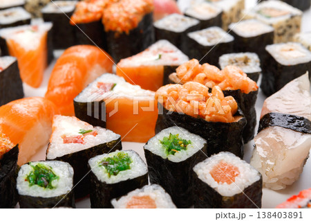 Japanese food restaurant delivery closeup - sushi and rolls platter set at white background 138403891