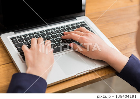 Business woman working in office, typing on laptop, close-up, shallow depth of field Business woman working in office, typing on laptop, close-up, shallow depth of field 138404191