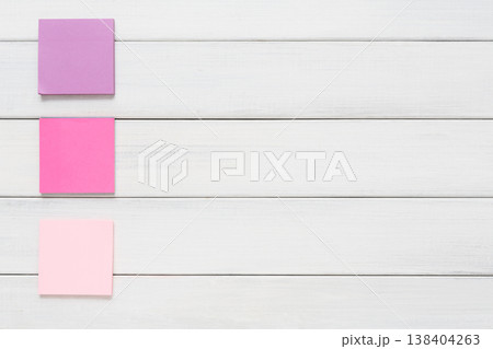 Stationery office and school supply concept - flat lay of colorful sticky notes on white rustic wooden board background, top view with copy space on paper, nobody, objects Stationery office and school supply concept - flat lay of colorful sticky notes on white rustic wooden board background, top view with copy space on paper, nobody, objects 138404263