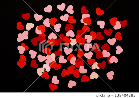 Valentines day romantic background. Pink and red paper hearts at black backdrop, top view, copy space Valentines day romantic background. Pink and red paper hearts at black backdrop, top view, copy space 138404293