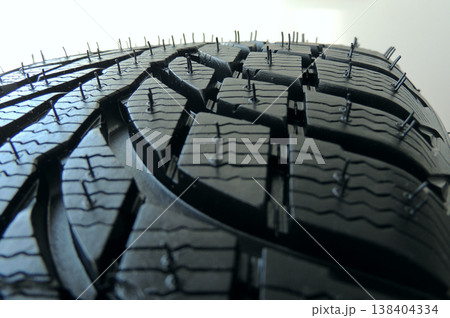 Part of new vehicle tire close up stock photo. Close up of a New Tire Tread 138404334