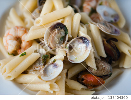 Cooked Pasta with shells and prawns close-up. 138404360