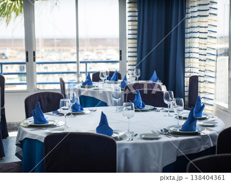 Fold round table with blue napkins in the restaurant. 138404361