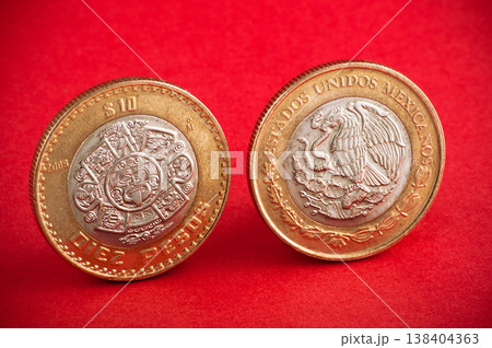Ten mexican coin on red background. Shot close up 138404363