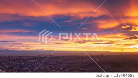 Dramatic sky with clouds painted in sunset hues over cityscape Dramatic sky with clouds painted in sunset hues over cityscape 138404688
