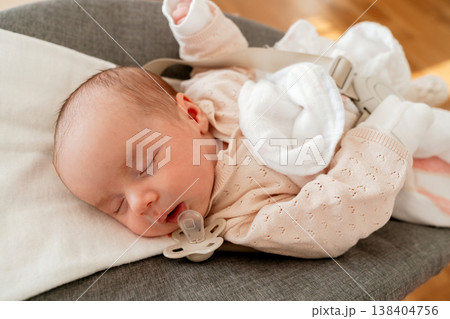Infant resting with pacifier during daytime nap. Concept of healthy sleep, comfort and safe environment for baby development. Infant resting with pacifier during daytime nap. Concept of healthy sleep, comfort and safe environment for baby development. 138404756
