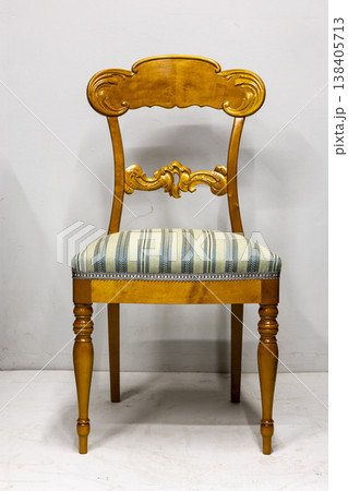 Elegant vintage wooden chair with a striped cushion perfect for classic home decor 138405713