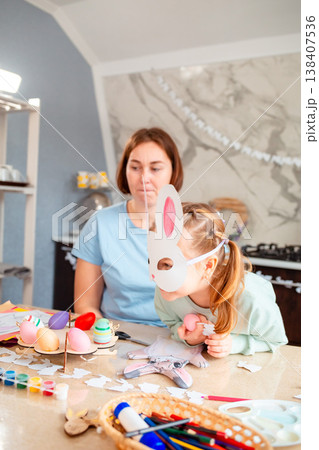 Caucasian mother teaching her daughter to prepare for Easter, crafting decorations and decorating the room, family traditions, parenting, childhood development and holiday atmosphere. Caucasian mother teaching her daughter to prepare for Easter, crafting decorations and decorating the room, family traditions, parenting, childhood development and holiday atmosphere. 138407536