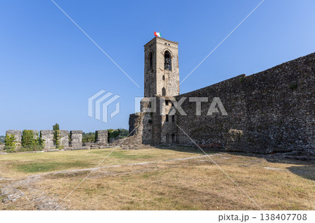 Medieval belfry and surviving defensive wall stand in the castle ruins of Cavriana 138407708