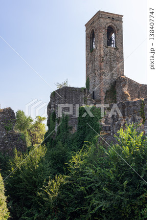 Bell tower and ivy covered castle ruins rise above the overgrown moat in Cavriana Lombardy Bell tower and ivy covered castle ruins rise above the overgrown moat in Cavriana Lombardy 138407747