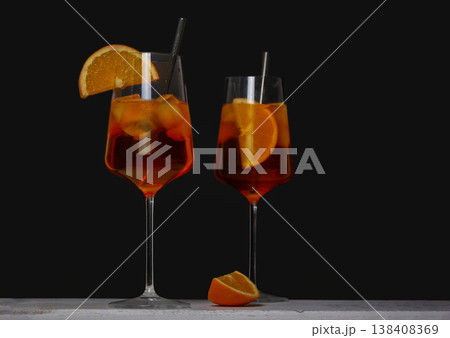 Aperol Spritz Cocktails with Orange Garnish on Black Background Aperol Spritz Cocktails with Orange Garnish on Black Background 138408369