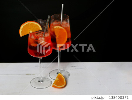 Aperol Spritz Cocktails with Orange Garnish on Black Background Aperol Spritz Cocktails with Orange Garnish on Black Background 138408371
