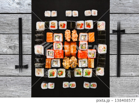 Japanese food restaurant delivery - sushi maki, unagi, gunkan and roll big party platter set on gray wood background, above view 138408577