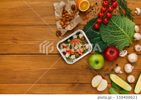 Healthy food delivery background. Lunch box with salad on rustic wood table, copy space 138408621