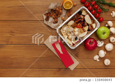 Healthy food delivery background. Lunch box with apples, nuts and salad on rustic wood table, copy space 138408643