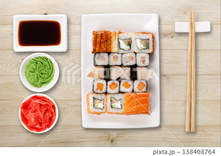 Japanese food restaurant delivery - sushi maki, unagi and roll platter set isolated on natural wood background, above view Japanese food restaurant delivery - sushi maki, unagi and roll platter set isolated on natural wood background, above view 138408764