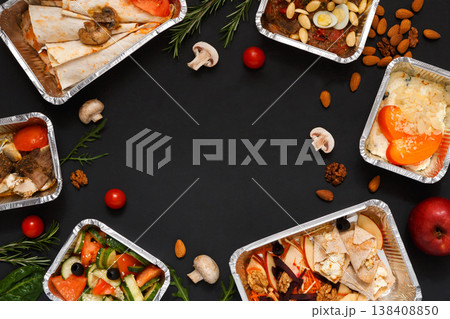 Healthy restaurant food delivery background with copy space. Mockup for menu, foil containers with meals on black Healthy restaurant food delivery background with copy space. Mockup for menu, foil containers with meals on black 138408850
