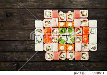 Japanese food restaurant, sushi maki gunkan roll plate or platter set. Unagi Sushi at rustic wood background. Top view, flat lay. Big party sushi set. Japanese food restaurant, sushi maki gunkan roll plate or platter set. Unagi Sushi at rustic wood background. Top view, flat lay. Big party sushi set. 138408851
