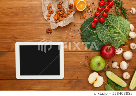 Healthy food, grocery online shopping, copy space on tablet screen. Fresh organic vegetables and fruits on wood table, top view, flat lay 138408853
