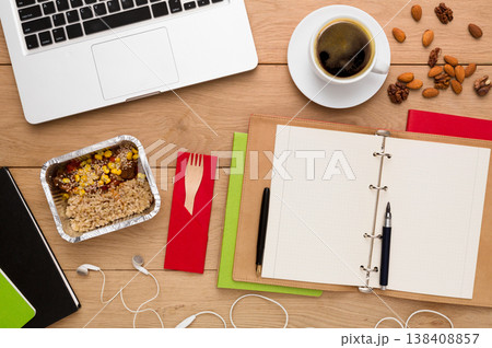 Healthy food delivery. Lunch box with diet meal on workplace, flat lay of wooden desktop with foiled container, copy space 138408857