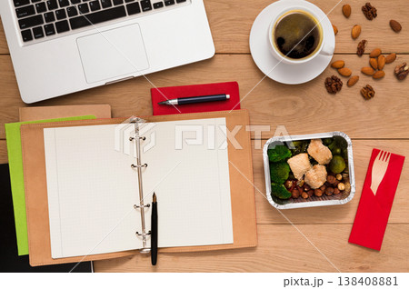 Healthy food delivery. Lunch box with diet meal on workplace, flat lay of wooden desktop with foiled container, copy space 138408881