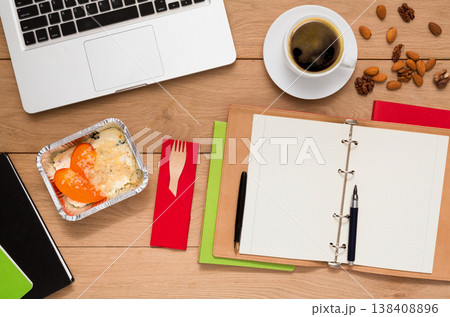 Healthy lunch at workplace. Foil box with diet meal, flat lay of wooden desktop with foiled container, copy space 138408896